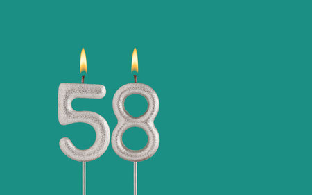Birthday card on a green background - Candle in the shape of the number 58