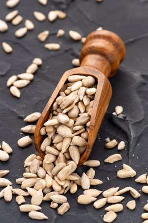 Shelled sunflower seeds in a spoon - Helianthus annuus.の写真素材