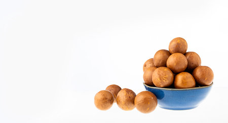 Organic macadamia nuts in bowl - Macadamia integrifolia.の写真素材