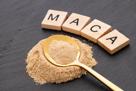 Ground organic maca in the spoon - Lepidium meyenii