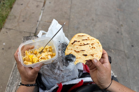 Colombian woman with plastic container, where she has her food.の写真素材