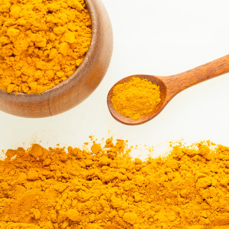 Organic turmeric powder in a spoon and bowl - Curcuma longaの写真素材