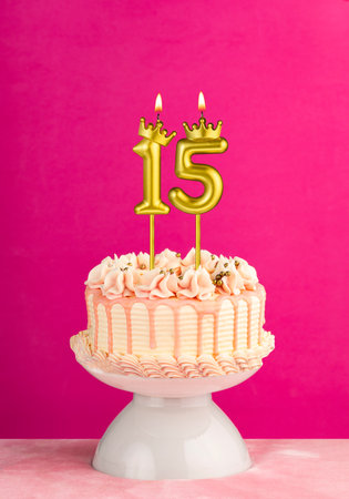 Number 15 birthday candle - Pink celebration cake with drip icingの写真素材