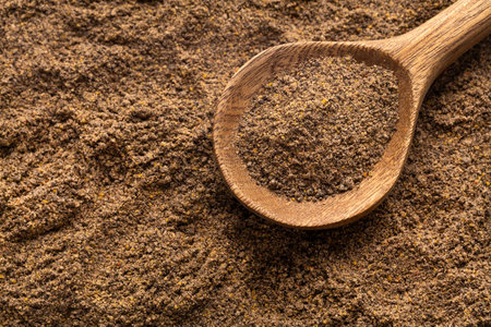 Piper nigrum - Aromatic black pepper on a spoon
