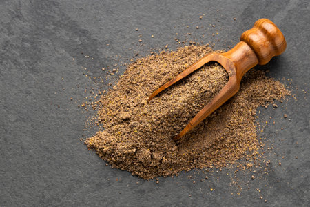 Organic ground black pepper on a spoon - Piper nigrum