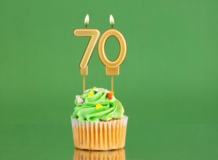 Birthday card with candle and cupcake - Number 70 on a green backgroundの写真素材