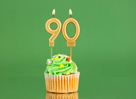 Birthday card with candle and cupcake - Number 90 on a green backgroundの写真素材
