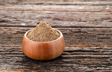 Organic ground black pepper in a bowl - Piper nigrumの写真素材