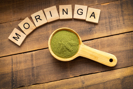 Pure dried moringa powder in a spoon - Moringa oleiferaの写真素材