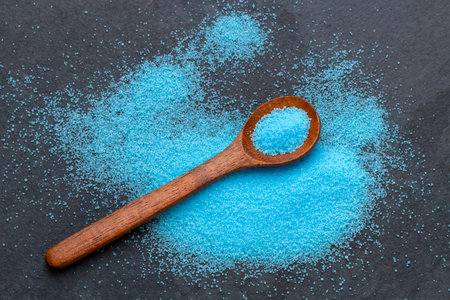 Fine blue salt crystals in a spoon - Potassium fluorideの写真素材