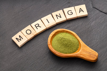 Organic dried moringa powder in a spoon - Moringa oleiferaの写真素材