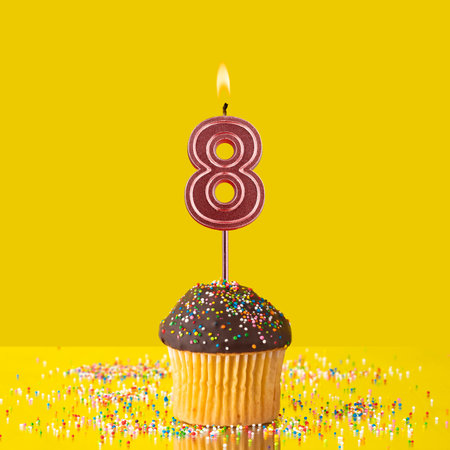 Birthday on a yellow background - Number 8 candleの写真素材