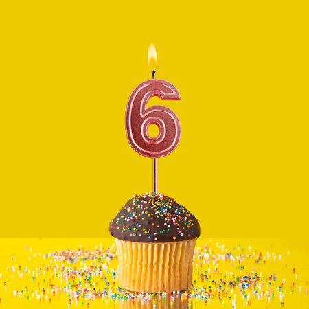 Birthday on a yellow background - Number 6 candleの写真素材
