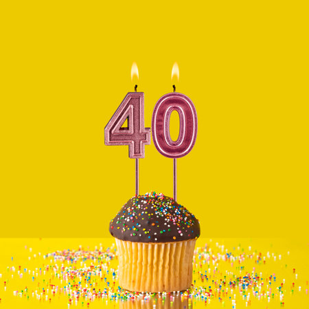 Birthday on a yellow background - Number 40 candleの写真素材