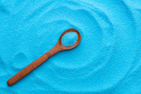 Bright blue copper sulfate in a spoon - Blue sea saltの写真素材