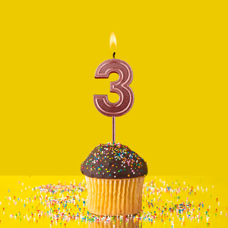 Number 3 candle - Birthday candle with chocolate cupcakeの写真素材