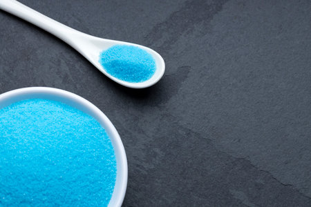 Fine and pure blue salt in a spoon and bowl - Sodium chlorideの写真素材