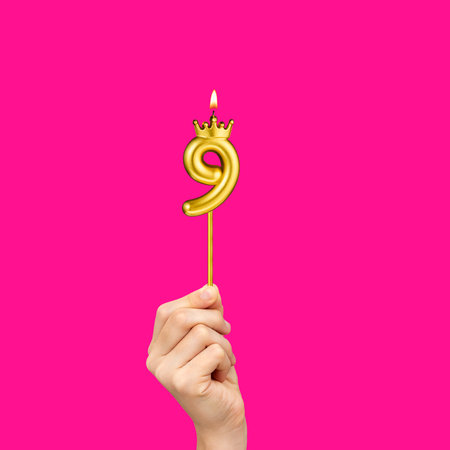 Birthday on a fuchsia background with the number 9 - Hands holding number-shaped candles