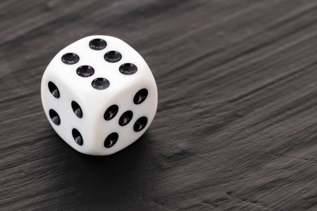 one board game dice - White die with black dots
