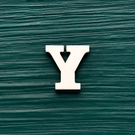 Alphabet letter Y, white piece on a dark green rustic background