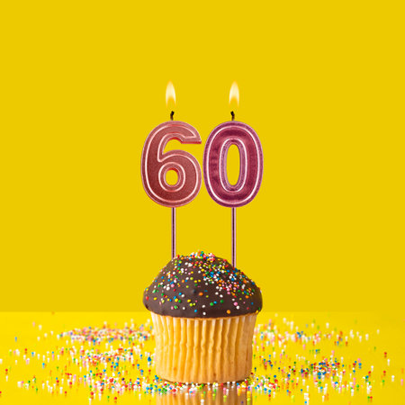 Birthday on a yellow background - Number 60 candleの写真素材