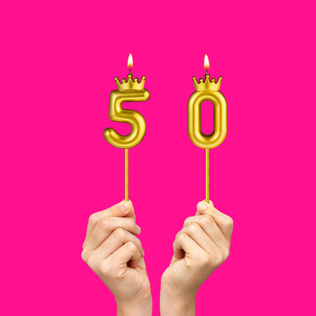 Hands holding number-shaped candles - Birthday number 50の写真素材