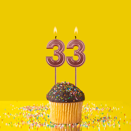 Number 33 candle - Birthday candle with chocolate cupcakeの写真素材