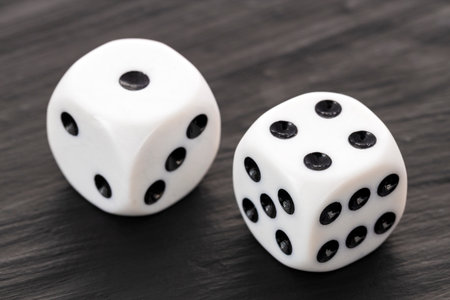 2 white dice with black dots in a row on a dark table