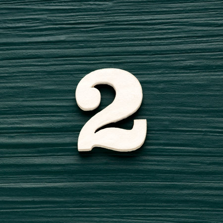 Number two - White wooden number on a rustic dark green background