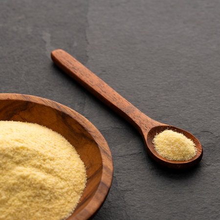 Wheat semolina in a wooden spoon and bowl - Triticum