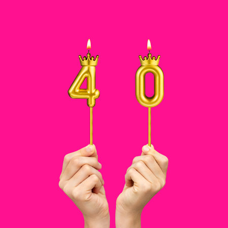 Hands holding number-shaped candles - Birthday number 40