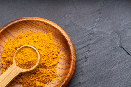 Turmeric is a very healthy species in the spoon and bowl - Curcuma longa