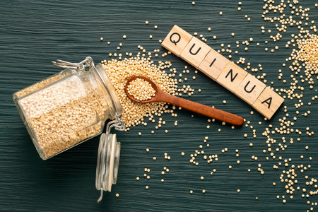 Organic quinoa seeds in a glass jar and spoon - Chenopodium quinoaの写真素材