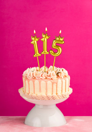 Number 115 birthday candle - Pink celebration cake with drip icingの写真素材
