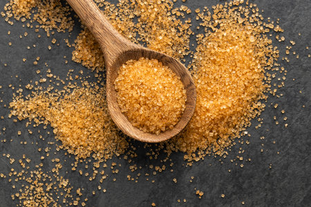 Organic brown cane sugar in spoon - Saccharum officinarumの写真素材