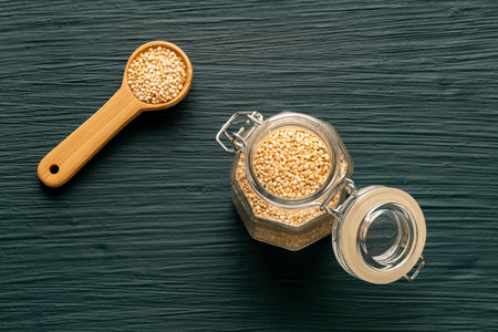 Chenopodium quinoa - Organic quinoa seeds in a glass jar with a lid and on the spoonの写真素材
