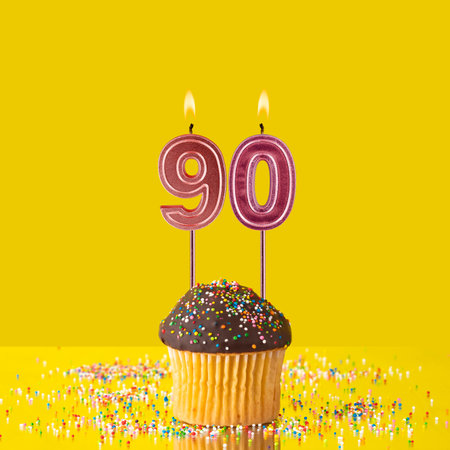 Birthday on a yellow background - Number 90 candleの写真素材