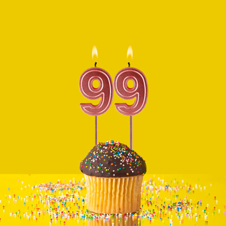 Number 99 candle - Birthday candle with chocolate cupcakeの写真素材