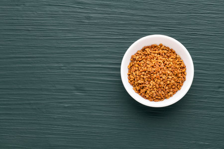 A bowl of organic fenugreek seeds - Trigonella foenum-graecumの写真素材