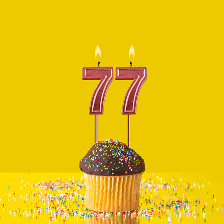 Number 77 candle - Birthday candle with chocolate cupcakeの写真素材