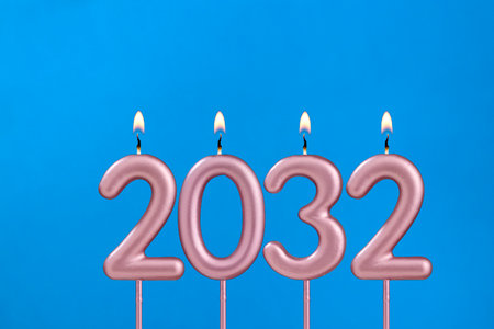Happy new year - Candles in the shape of a number on a blue background