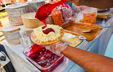Preparation of the wafer with caramel sauce, cheese and blackberry sweet - traditional Colombian...