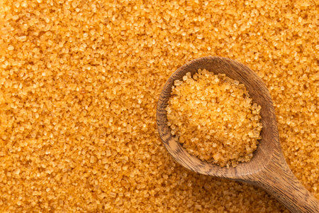 Organic brown sugar in a spoon - Saccharum officinarum.の写真素材