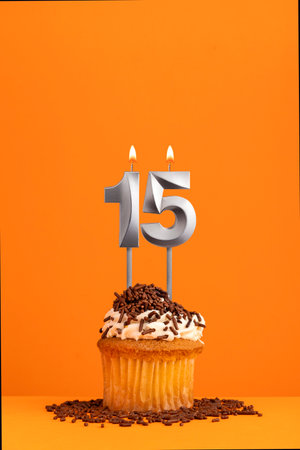 Birthday candle number 15 - Invitation card with orange background. cupcakeの写真素材