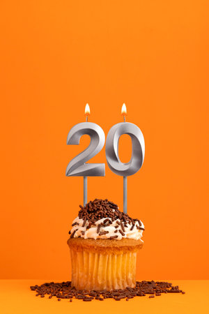 Number 20 candle - Birthday card design in orange background. cupcakeの写真素材