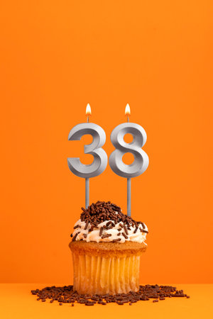 Number 38 candle - Birthday card design in orange background. cupcakeの写真素材