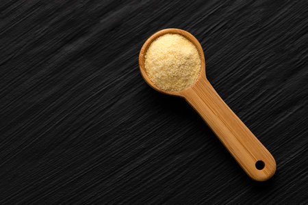 Coarse wheat semolina flour in a spoon - Triticumの写真素材