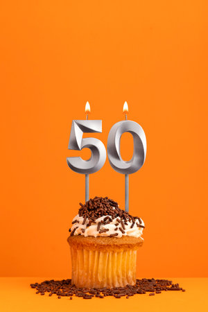 Number 50 candle - Birthday card design in orange background. cupcakeの写真素材