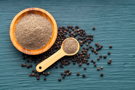 Flavored black pepper powder in a spoon and bowl - Piper nigrumの写真素材
