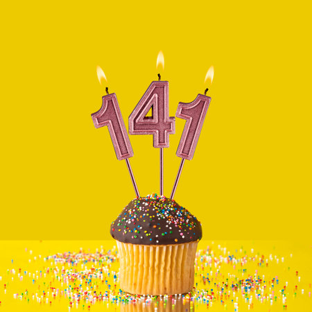 Candles forming the number 141 - Yellow background.の写真素材